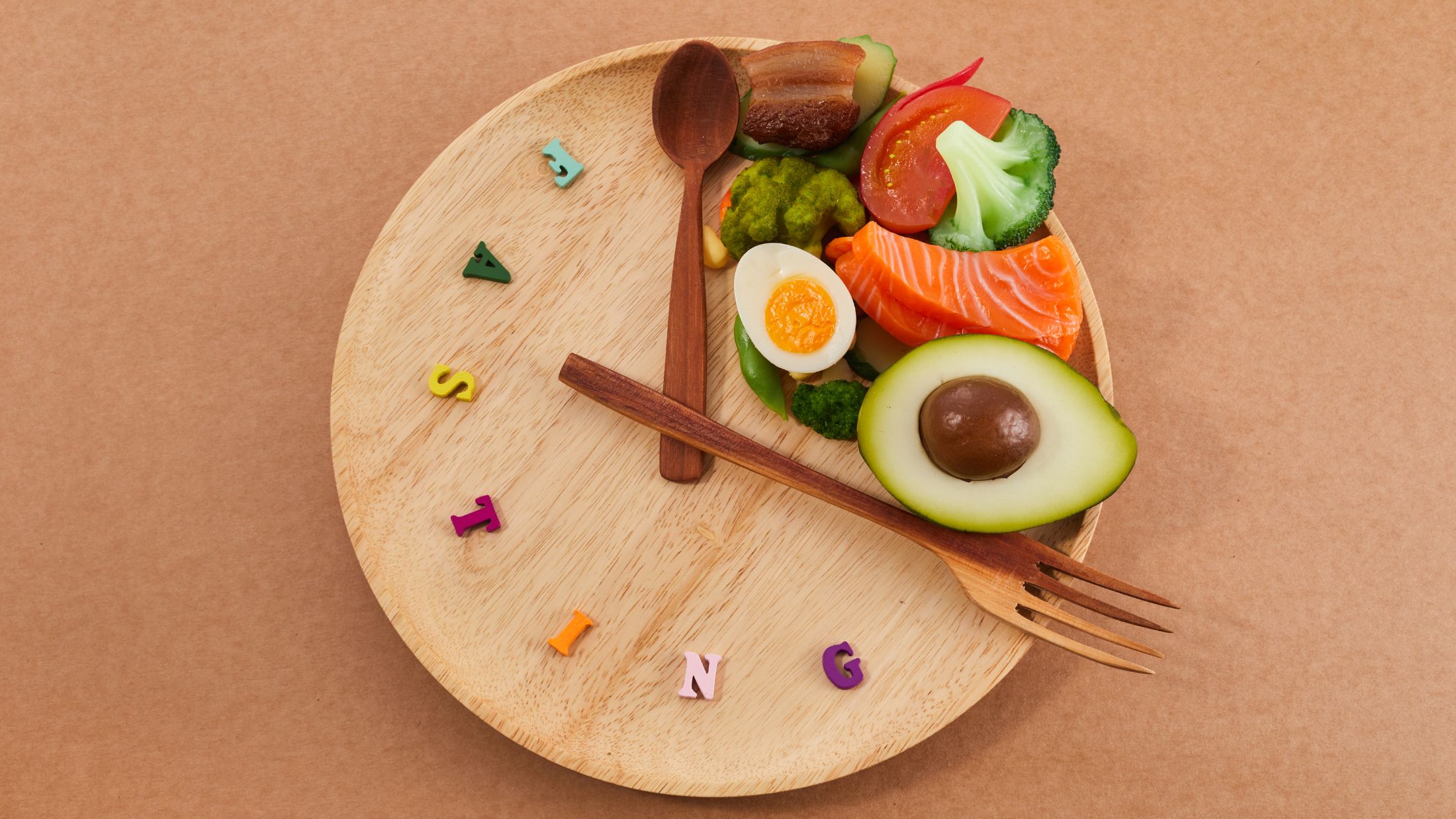 Creative representation of intermittent fasting with wooden plate with a clock face design. The food items on the plate could represent allowed eating periods during the day, while the empty space signifies fasting periods.