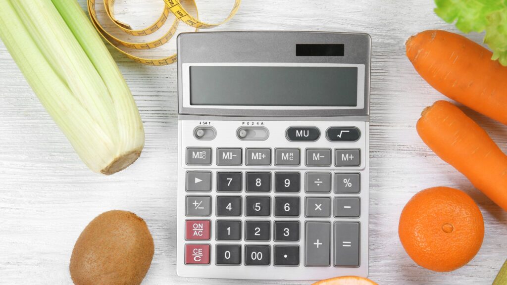 calculator surrounded with food