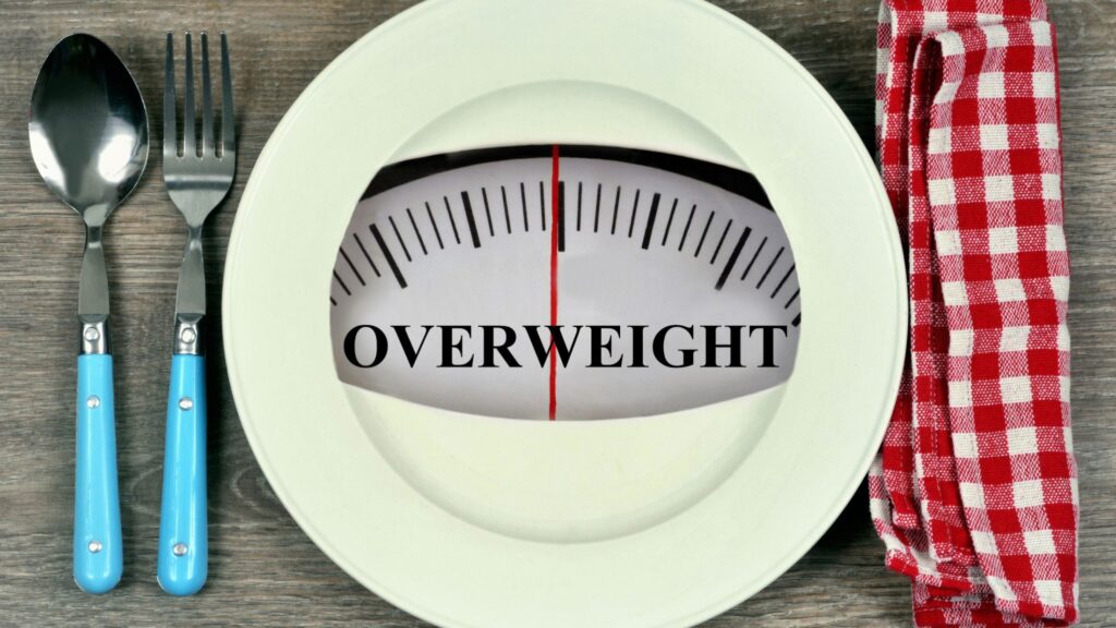 a scale with overweight label to debunk diet myths about overweight